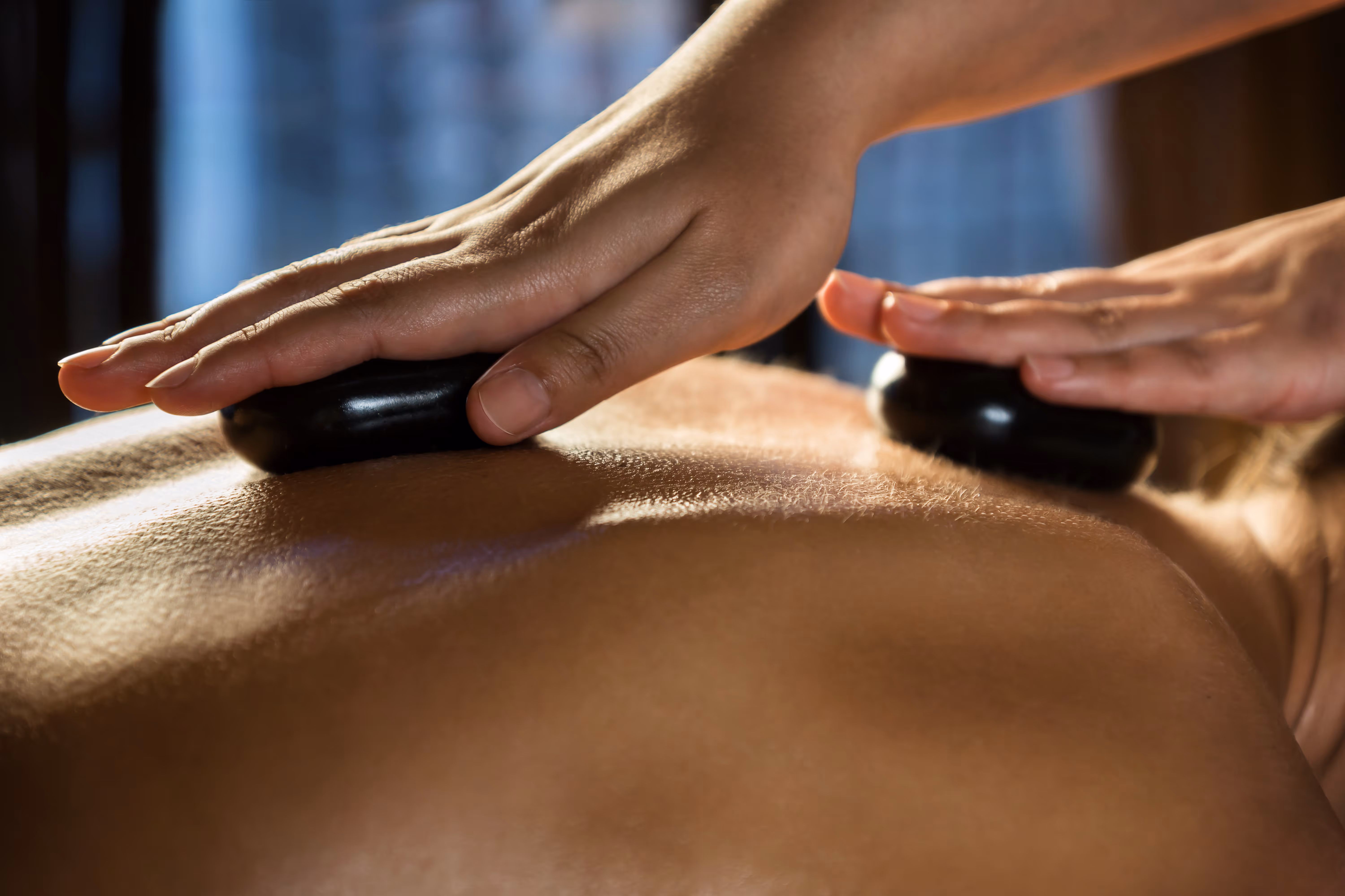Woman having Hot Stone Therapy Massage